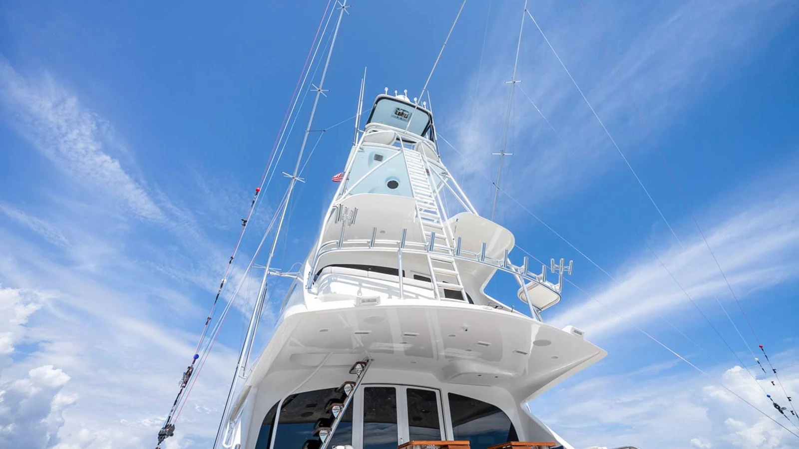 The yacht's towering structure stands out against a vibrant blue sky. aboard DOUBLE BARREL Yacht for Sale