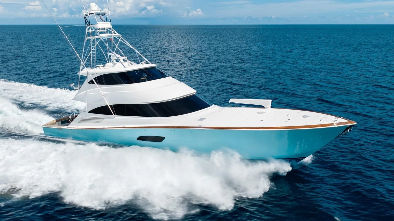 A sleek yacht cruises swiftly through the open sea, showcasing its elegant design and powerful performance. aboard DOUBLE BARREL Yacht for Sale