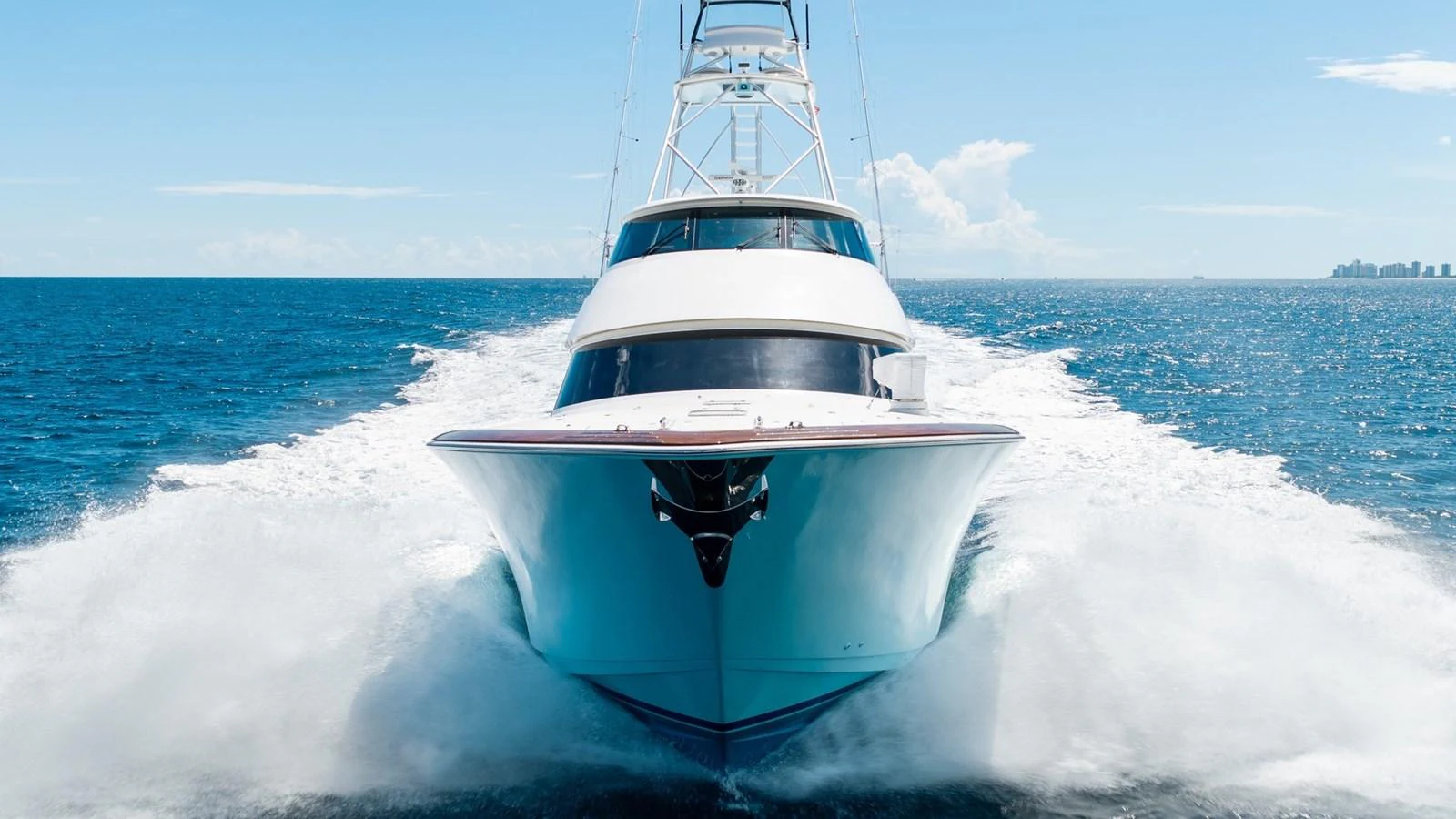 A sleek yacht cuts through the water, showcasing its powerful design and elegant lines. aboard DOUBLE BARREL Yacht for Sale