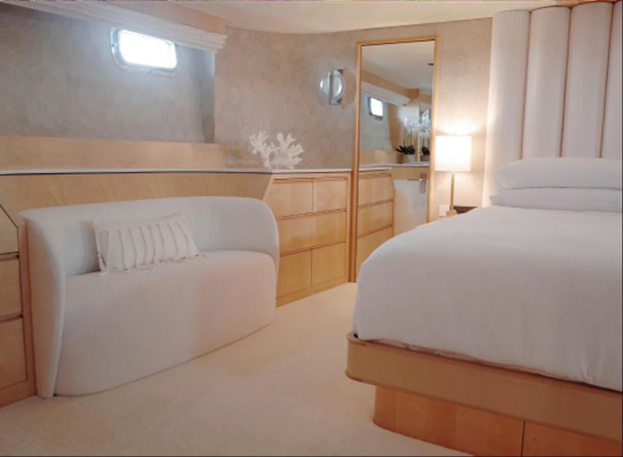 The stateroom features a cozy seating area and a plush bed, creating a serene and inviting atmosphere. aboard UKARA Yacht for Sale