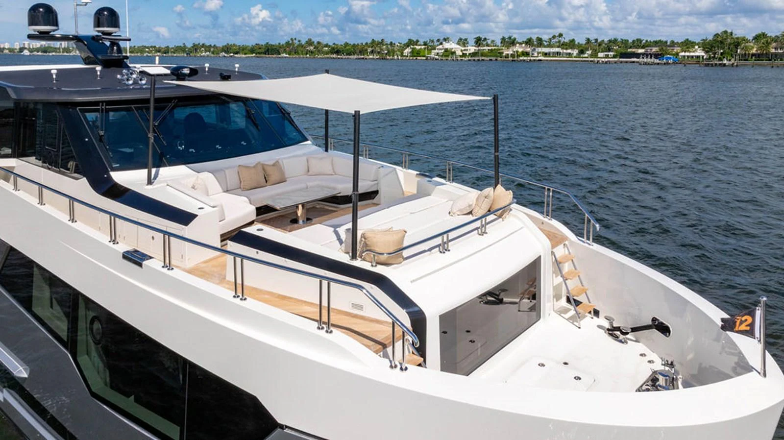 The yacht features a spacious flybridge with ample seating and a sunshade, perfect for relaxation and enjoying the view. aboard M/Y 12 Yacht for Sale