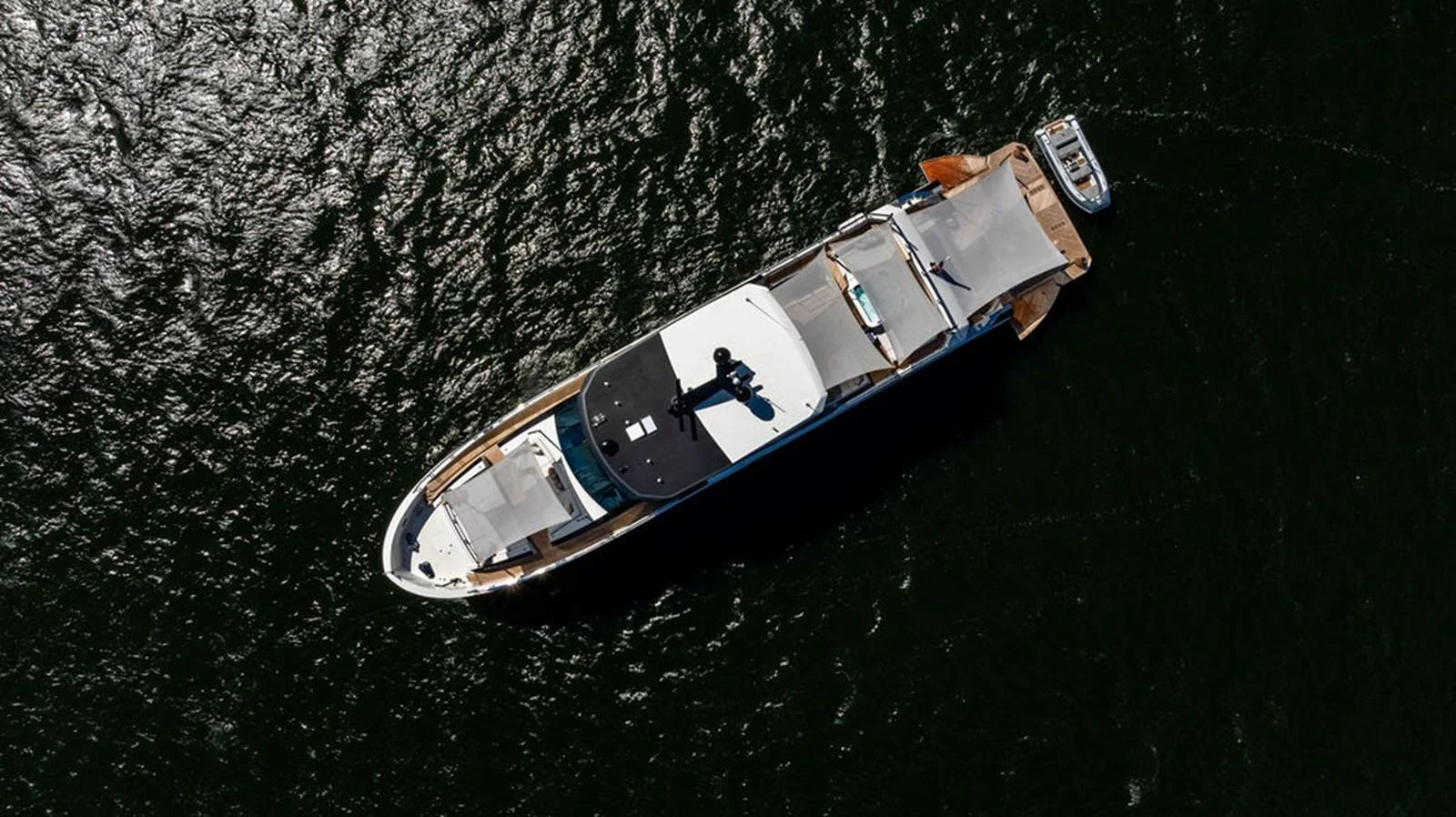 An aerial view of a sleek yacht cruising through dark waters. aboard M/Y 12 Yacht for Sale