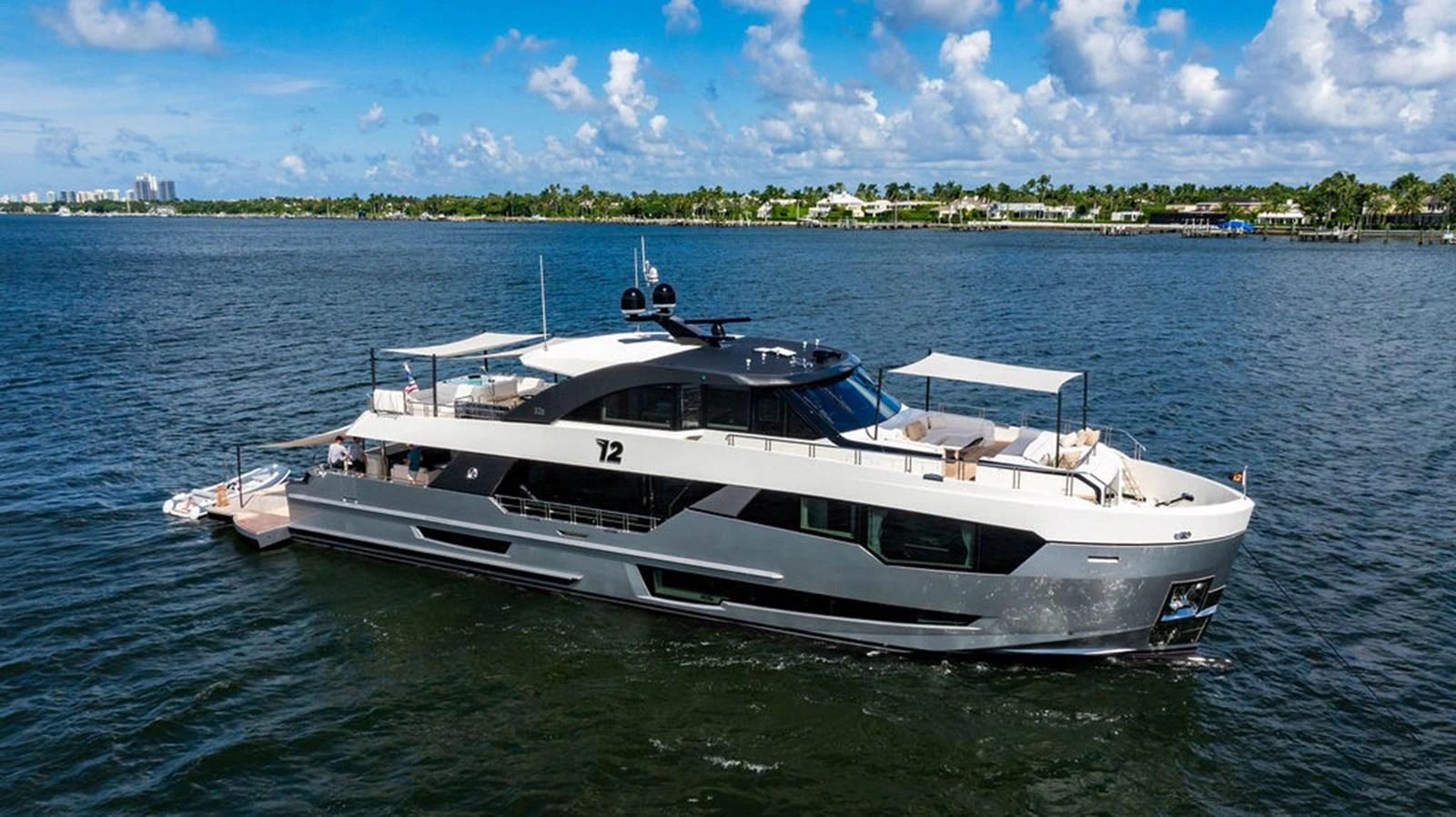 A sleek and modern yacht cruising on calm waters under a bright blue sky. aboard M/Y 12 Yacht for Sale