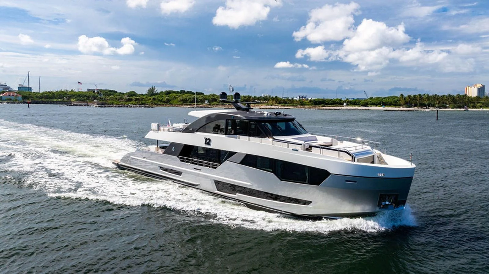 A sleek and modern yacht cruises gracefully through the water under a clear sky. aboard M/Y 12 Yacht for Sale