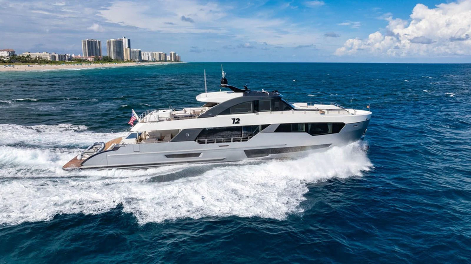 A sleek and modern yacht cruising swiftly on the open sea under a clear blue sky. aboard M/Y 12 Yacht for Sale