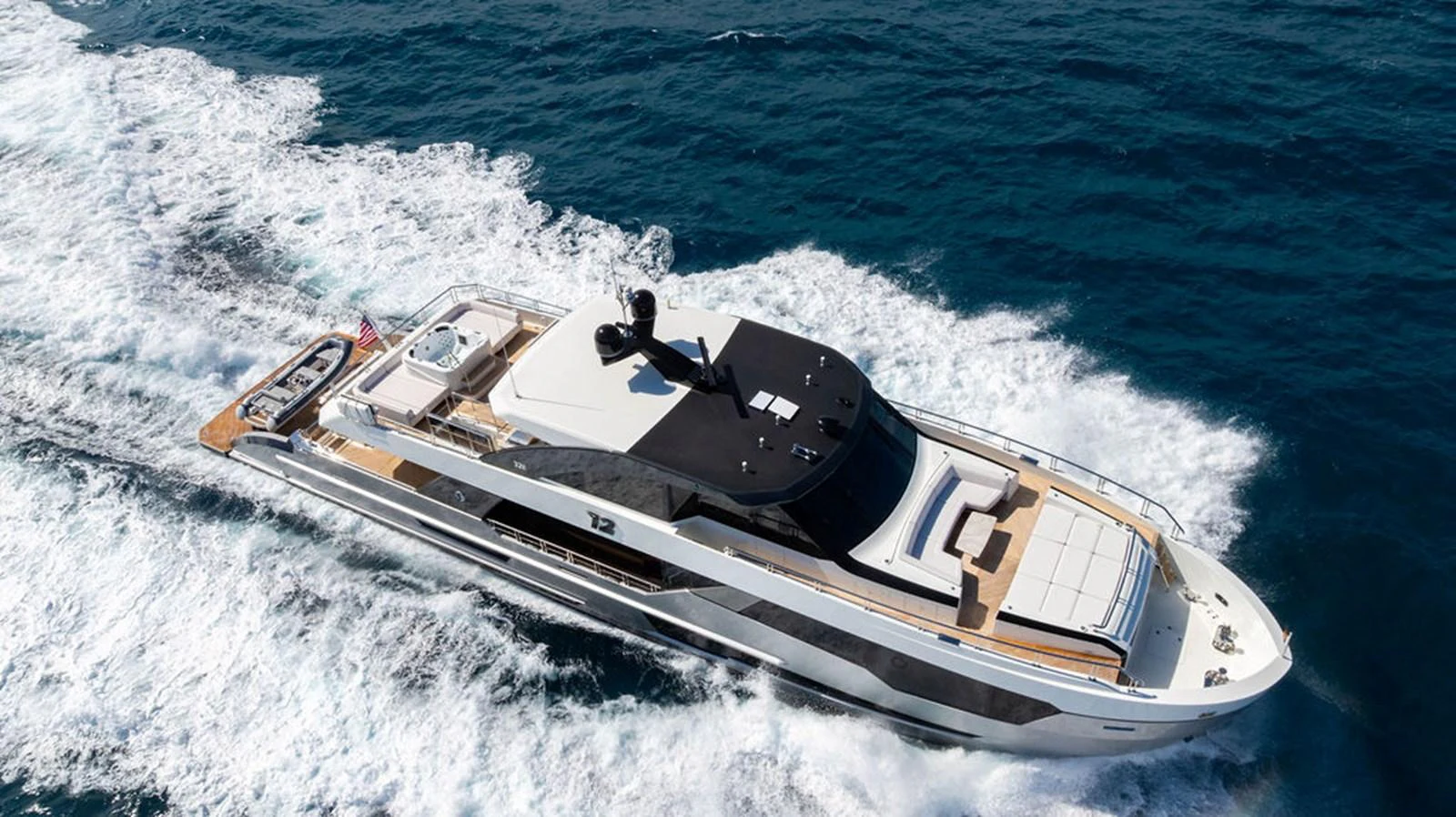 A sleek and modern yacht cruises swiftly through the open sea, showcasing its luxurious design and spacious deck areas. aboard M/Y 12 Yacht for Sale