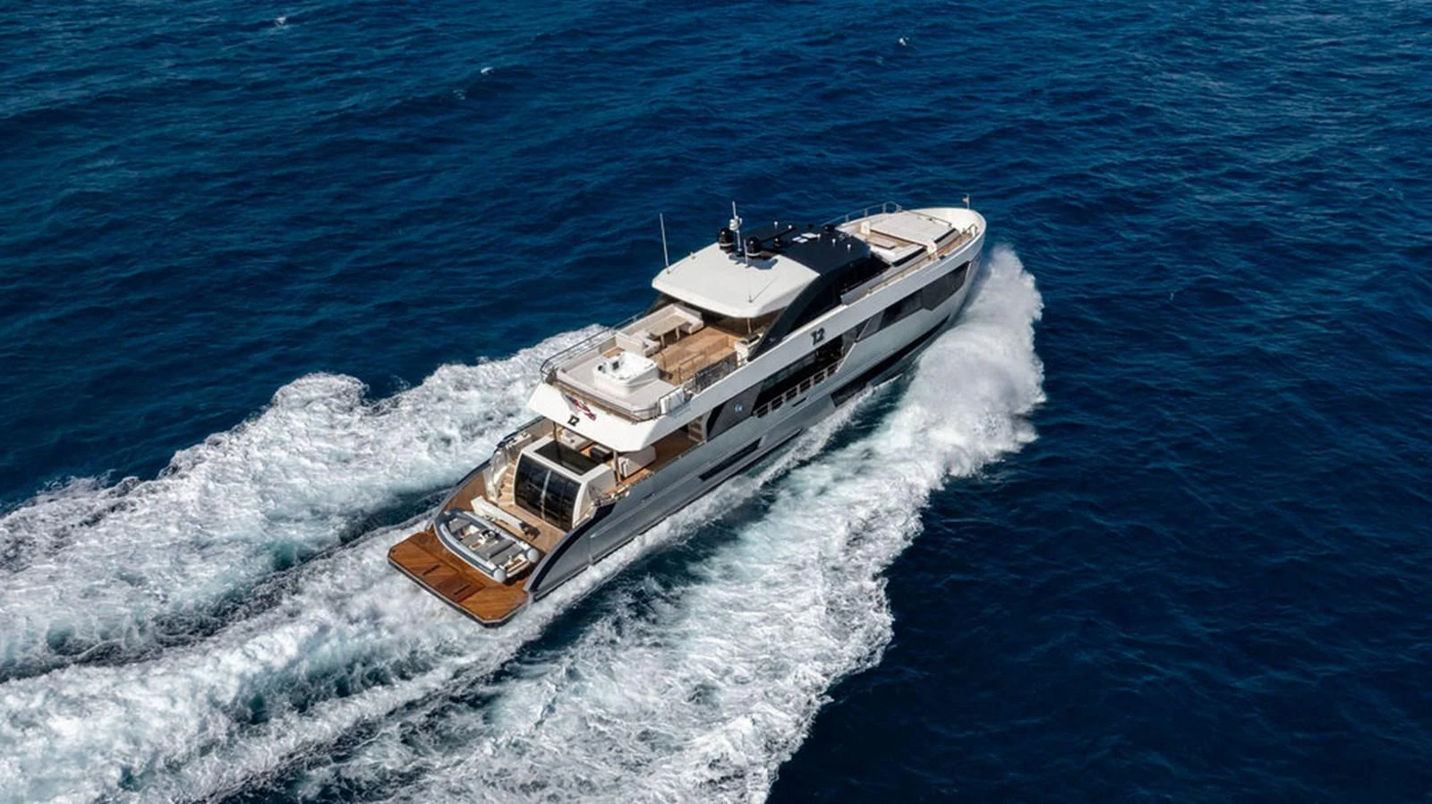 A sleek and modern yacht cruises swiftly through the open sea, showcasing its elegant design and spacious decks. aboard M/Y 12 Yacht for Sale