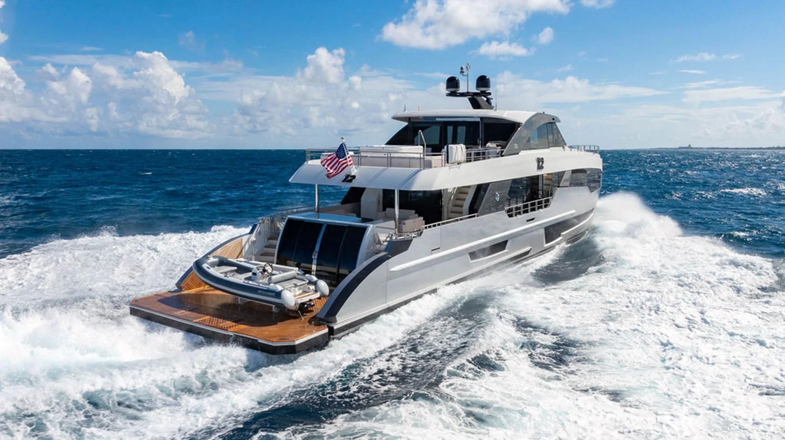 A sleek and modern yacht cruises through the open sea, showcasing its luxurious design and spacious deck. aboard M/Y 12 Yacht for Sale