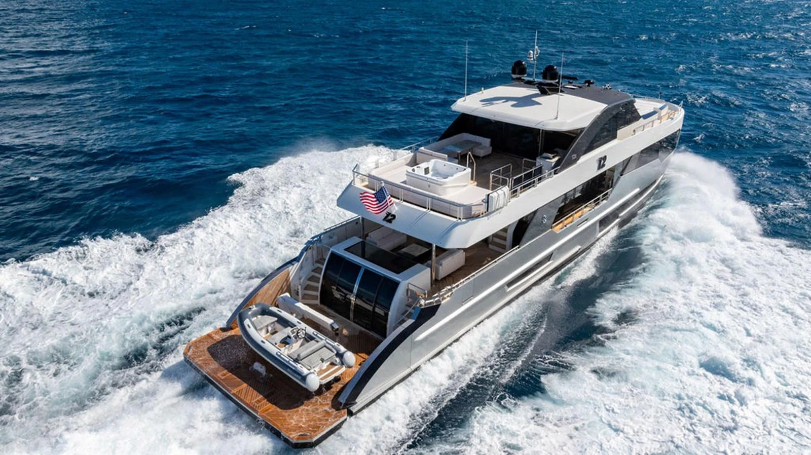 A sleek and modern yacht cruises through the open sea, showcasing its luxurious design and spacious deck. aboard M/Y 12 Yacht for Sale