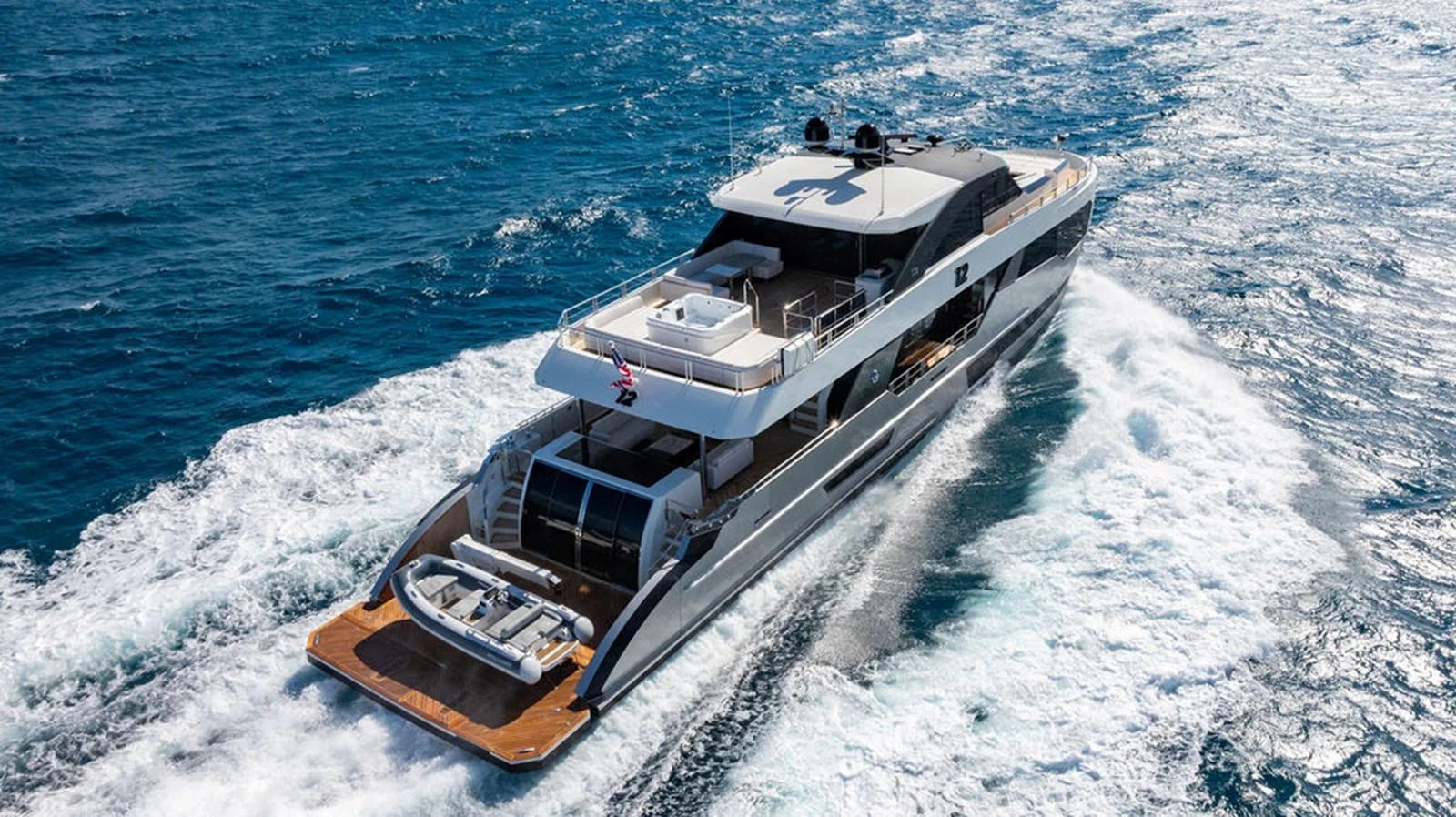 A sleek and modern yacht cruises swiftly through the open sea, showcasing its elegant design and spacious deck. aboard M/Y 12 Yacht for Sale