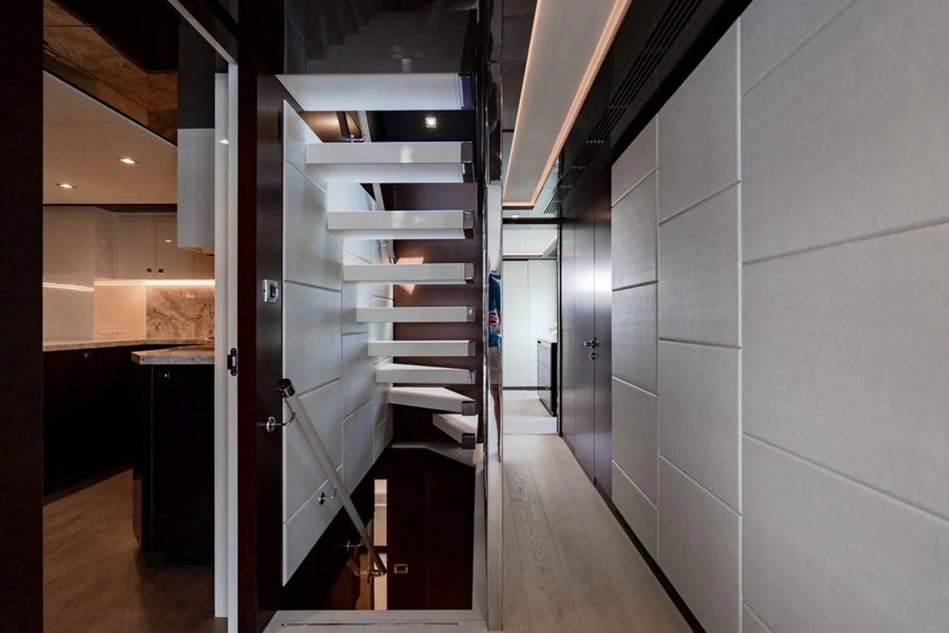 The interior of the yacht features a modern staircase and sleek corridor with contemporary design elements. aboard M/Y 12 Yacht for Sale
