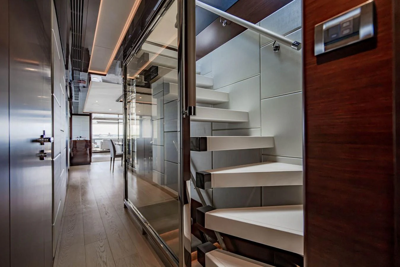 A modern yacht interior featuring a sleek staircase with glass and wood elements. aboard M/Y 12 Yacht for Sale