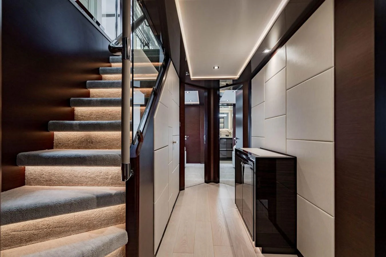 A luxurious hallway with modern lighting and elegant stairs leading to the upper deck. aboard M/Y 12 Yacht for Sale