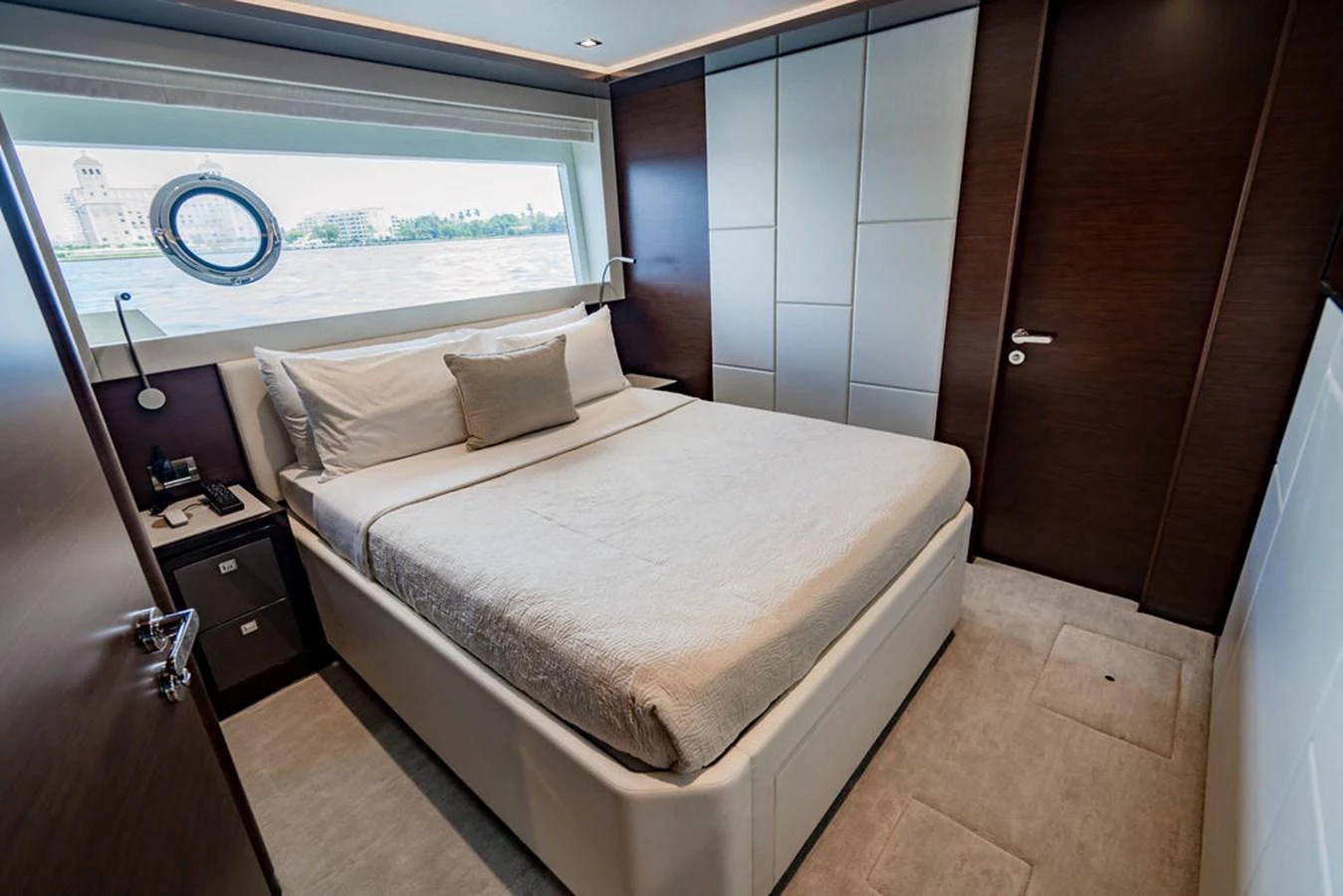 This cozy stateroom features a comfortable bed with a scenic view through the window. aboard M/Y 12 Yacht for Sale
