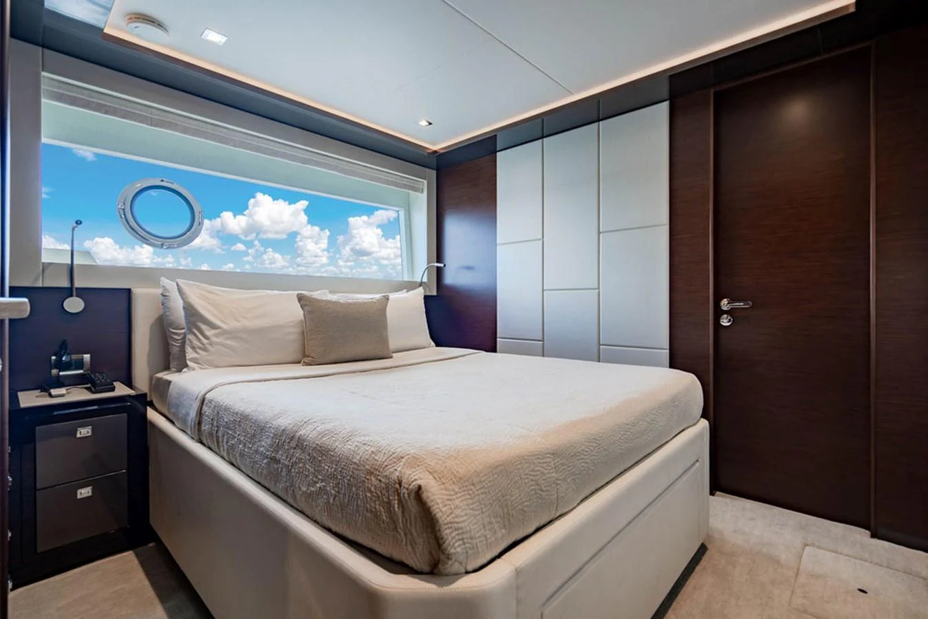 A luxurious stateroom featuring a large bed and a scenic window view. aboard M/Y 12 Yacht for Sale