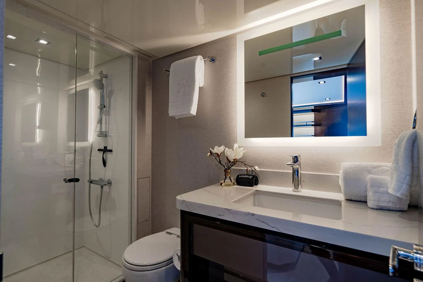 The yacht's bathroom features a sleek design with modern fixtures and a spacious shower. aboard M/Y 12 Yacht for Sale