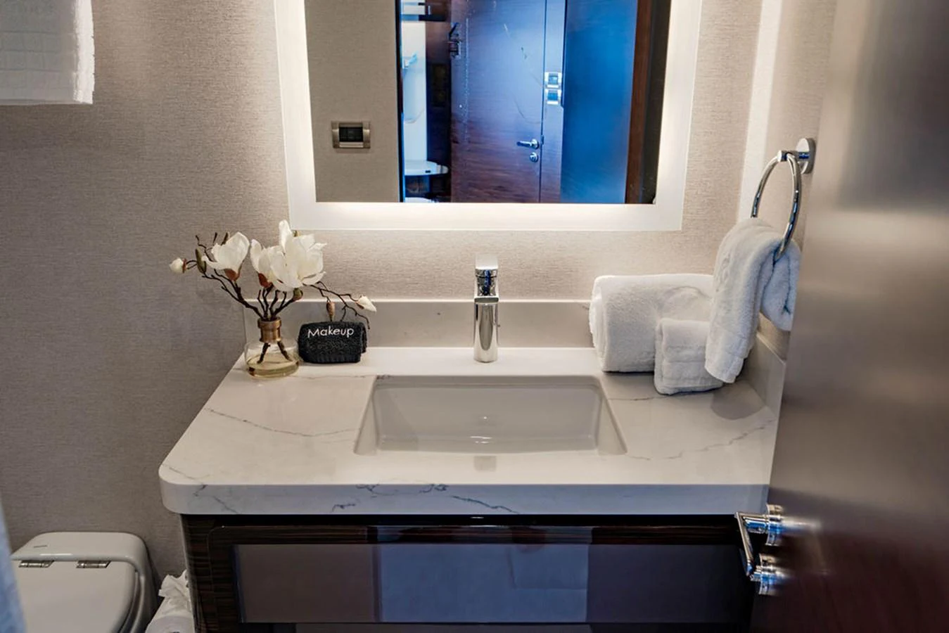A modern yacht bathroom featuring a sleek sink, elegant lighting, and tasteful decor. aboard M/Y 12 Yacht for Sale