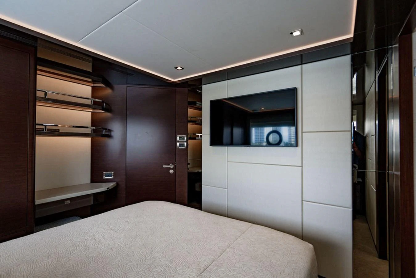 A luxurious stateroom featuring a large bed, modern decor, and a flat-screen TV. aboard M/Y 12 Yacht for Sale