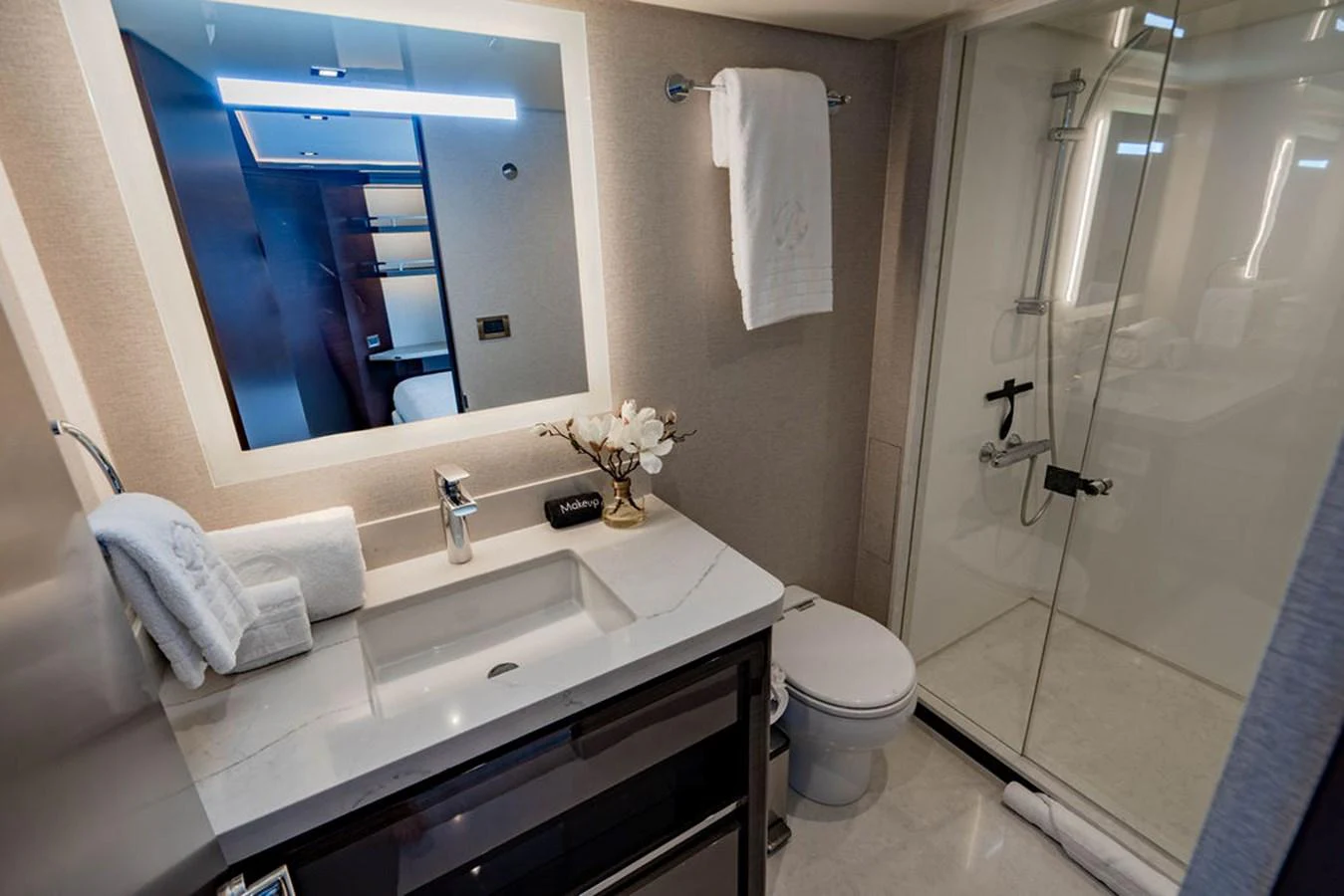 A modern and elegant yacht bathroom with a glass-enclosed shower and sleek fixtures. aboard M/Y 12 Yacht for Sale