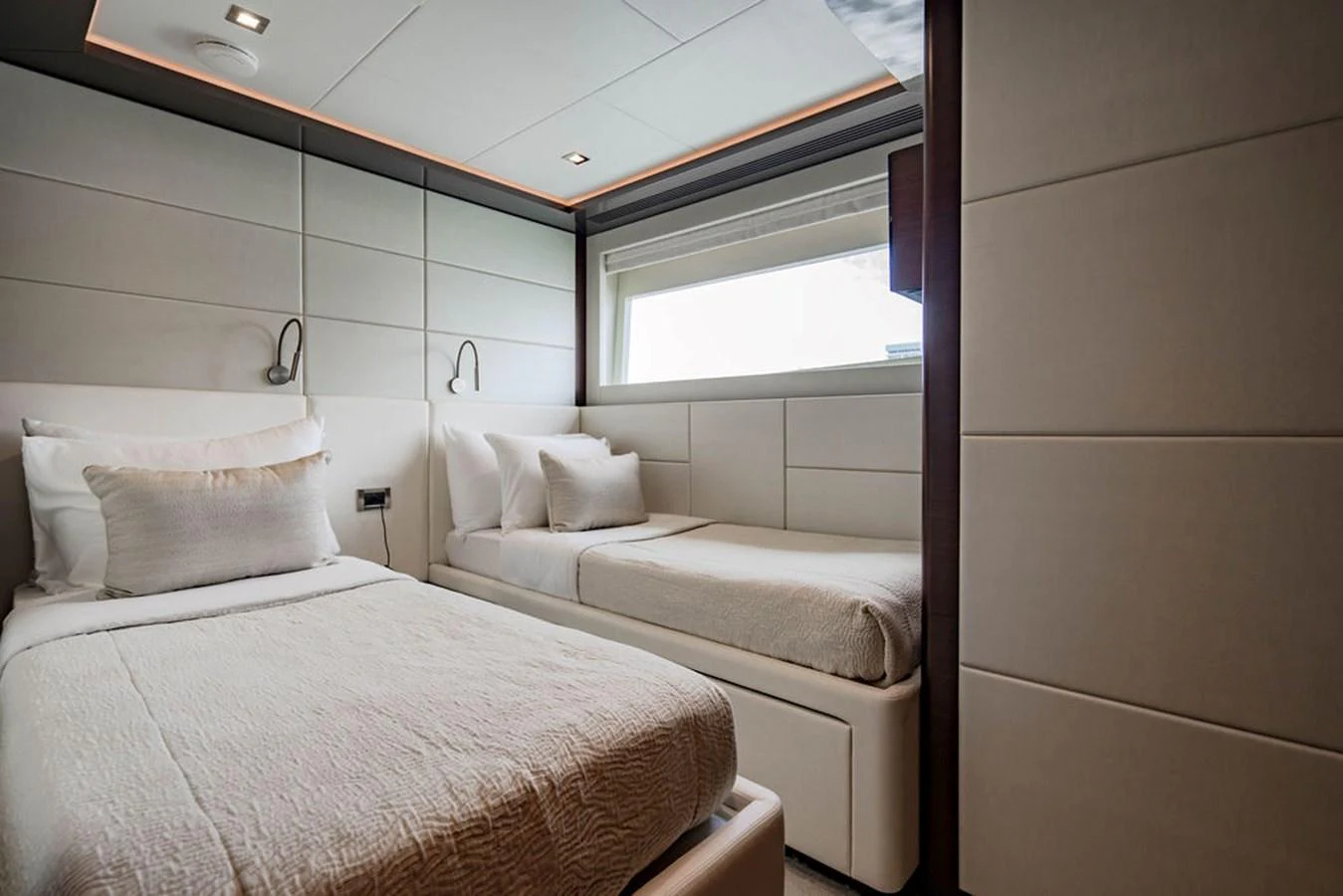 The guest stateroom features two comfortable single beds with modern decor and ample natural light. aboard M/Y 12 Yacht for Sale