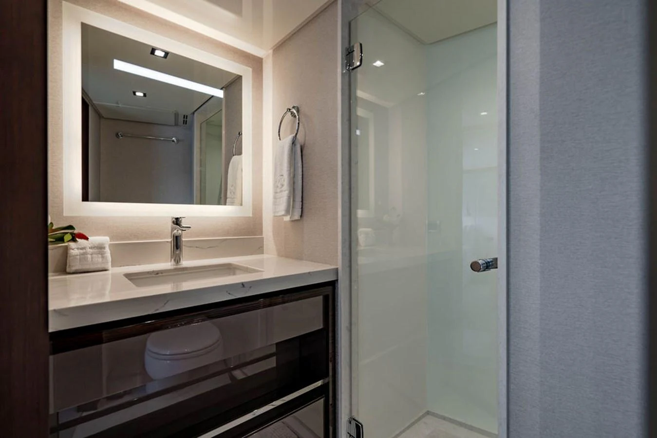 The yacht's bathroom features a sleek design with modern fixtures and a glass-enclosed shower. aboard M/Y 12 Yacht for Sale