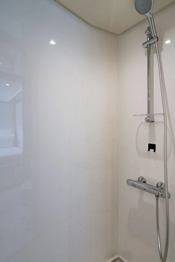 A sleek and modern shower area with a chrome showerhead and fixtures. aboard M/Y 12 Yacht for Sale