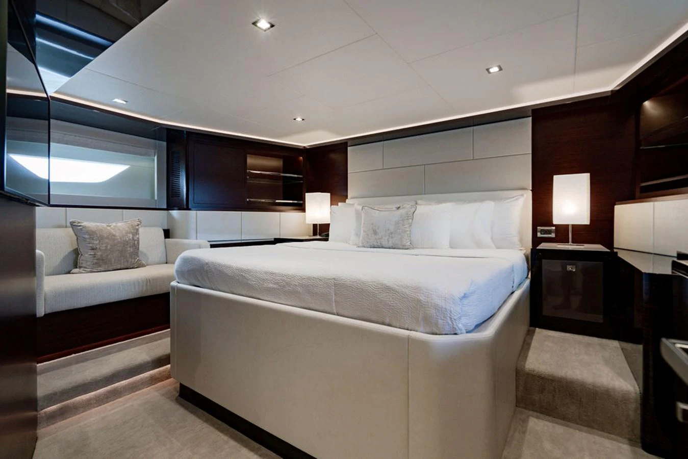 The master stateroom features a luxurious bed with elegant lighting and modern decor. aboard M/Y 12 Yacht for Sale