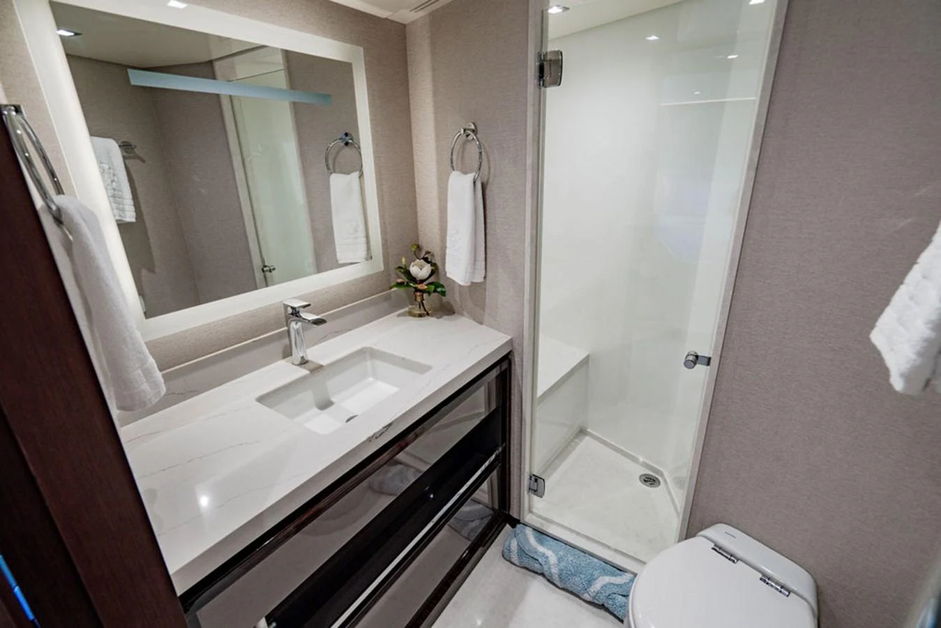 The yacht's bathroom features a sleek vanity, a modern shower, and elegant fixtures. aboard M/Y 12 Yacht for Sale