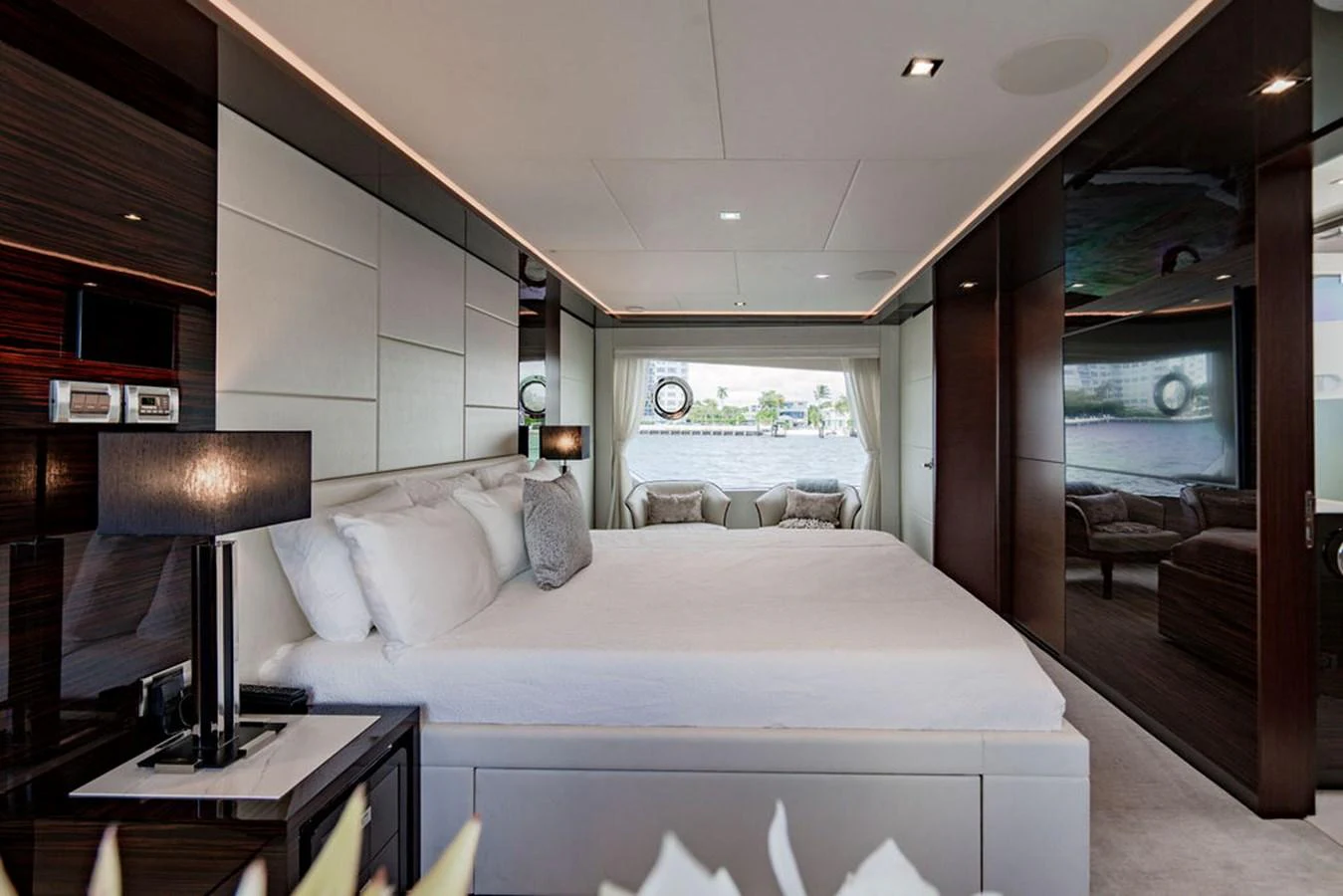 The master stateroom features a luxurious bed with elegant decor and a large window offering scenic views. aboard M/Y 12 Yacht for Sale