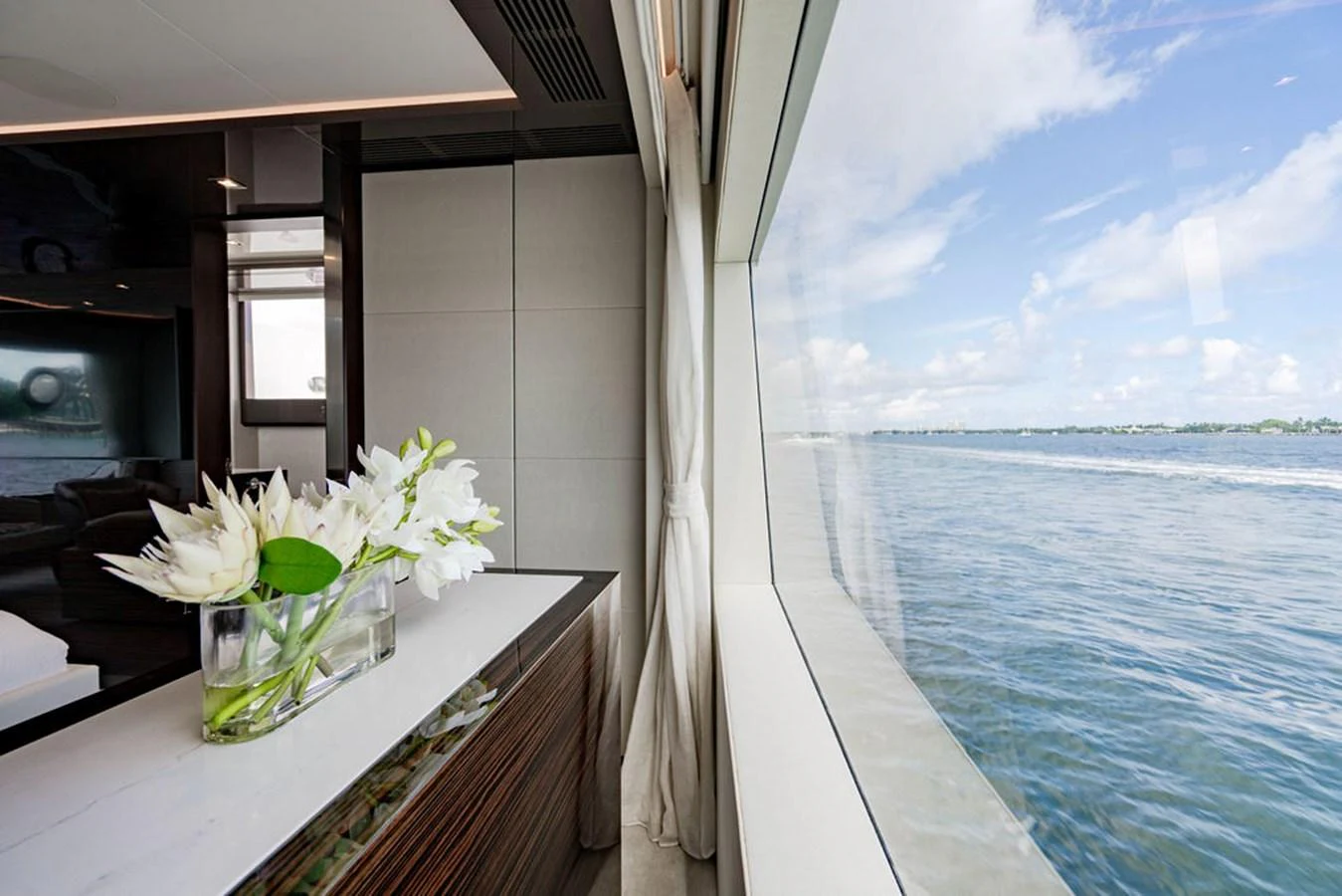 A serene interior space with a large window offering a stunning view of the water. aboard M/Y 12 Yacht for Sale