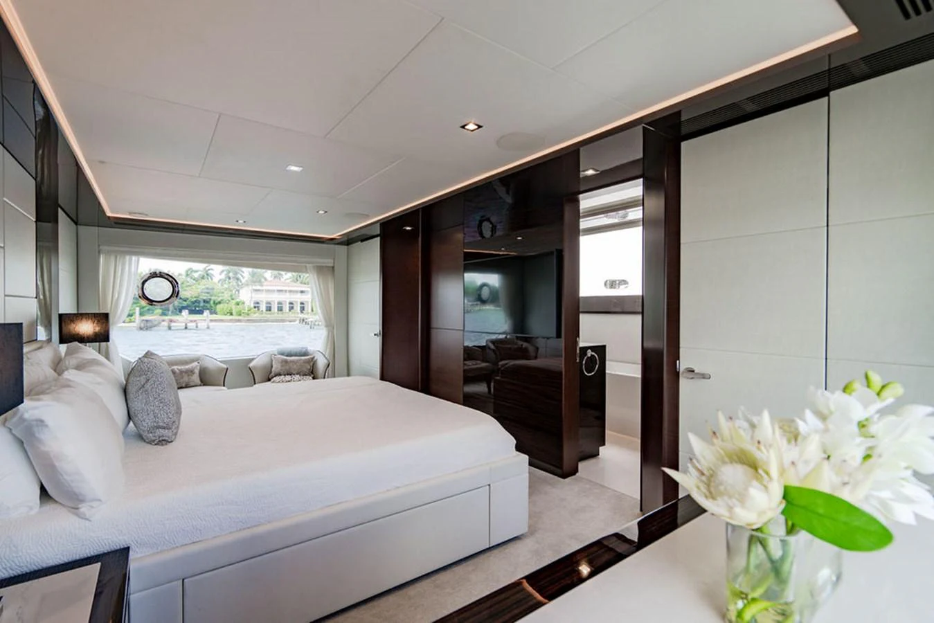 The master stateroom features a luxurious bed, elegant decor, and ample natural light. aboard M/Y 12 Yacht for Sale