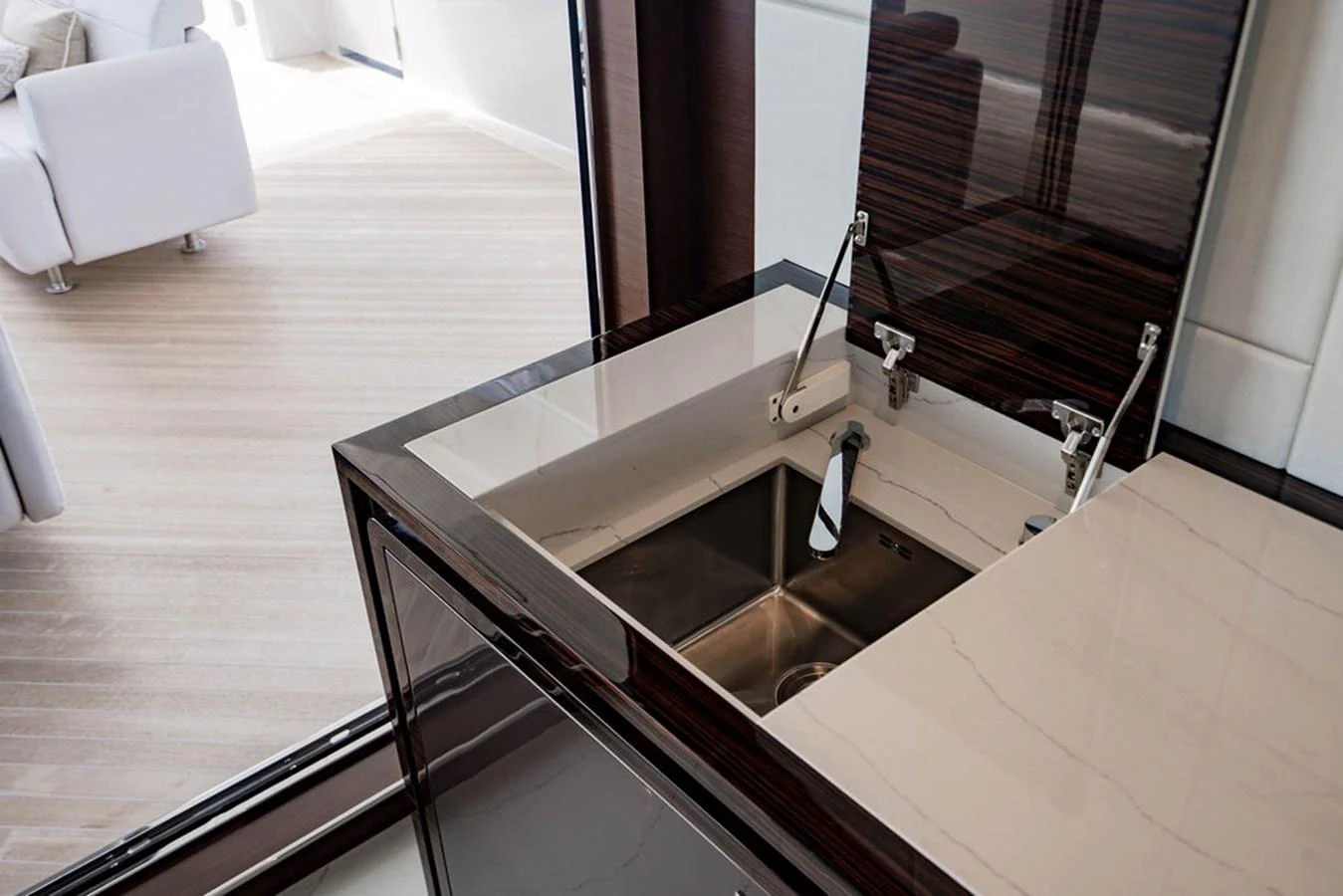 The image showcases a sleek and modern galley area with a stainless steel sink and high-gloss cabinetry. aboard M/Y 12 Yacht for Sale