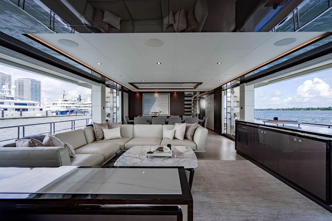 The spacious salon offers luxurious seating with panoramic views through large windows. aboard M/Y 12 Yacht for Sale