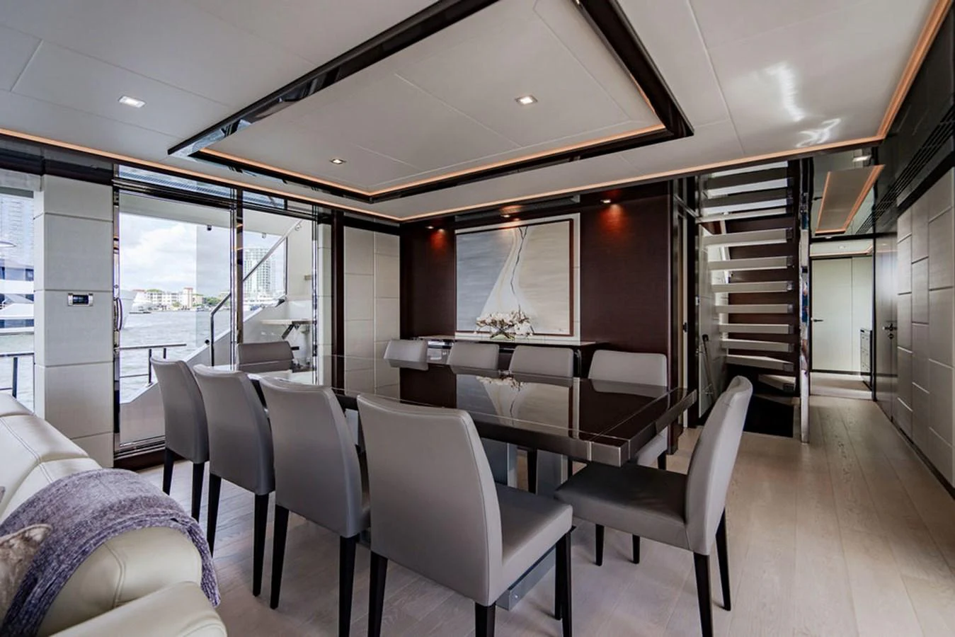 The yacht's dining area features a sleek table with comfortable seating and modern decor. aboard M/Y 12 Yacht for Sale
