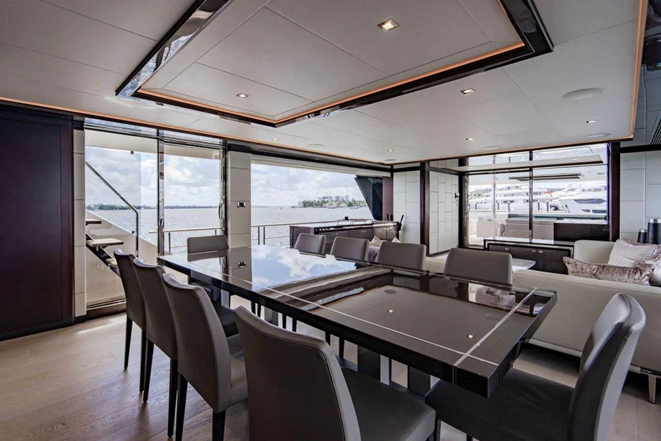 The yacht's dining area features a sleek table with comfortable seating and large windows offering stunning views. aboard M/Y 12 Yacht for Sale