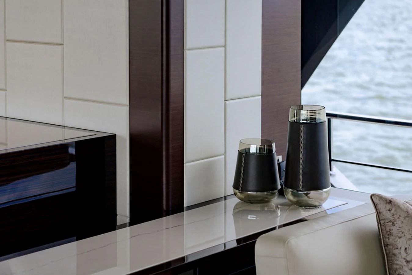 A sophisticated interior detail featuring modern decor elements and a partial view of the water outside. aboard M/Y 12 Yacht for Sale