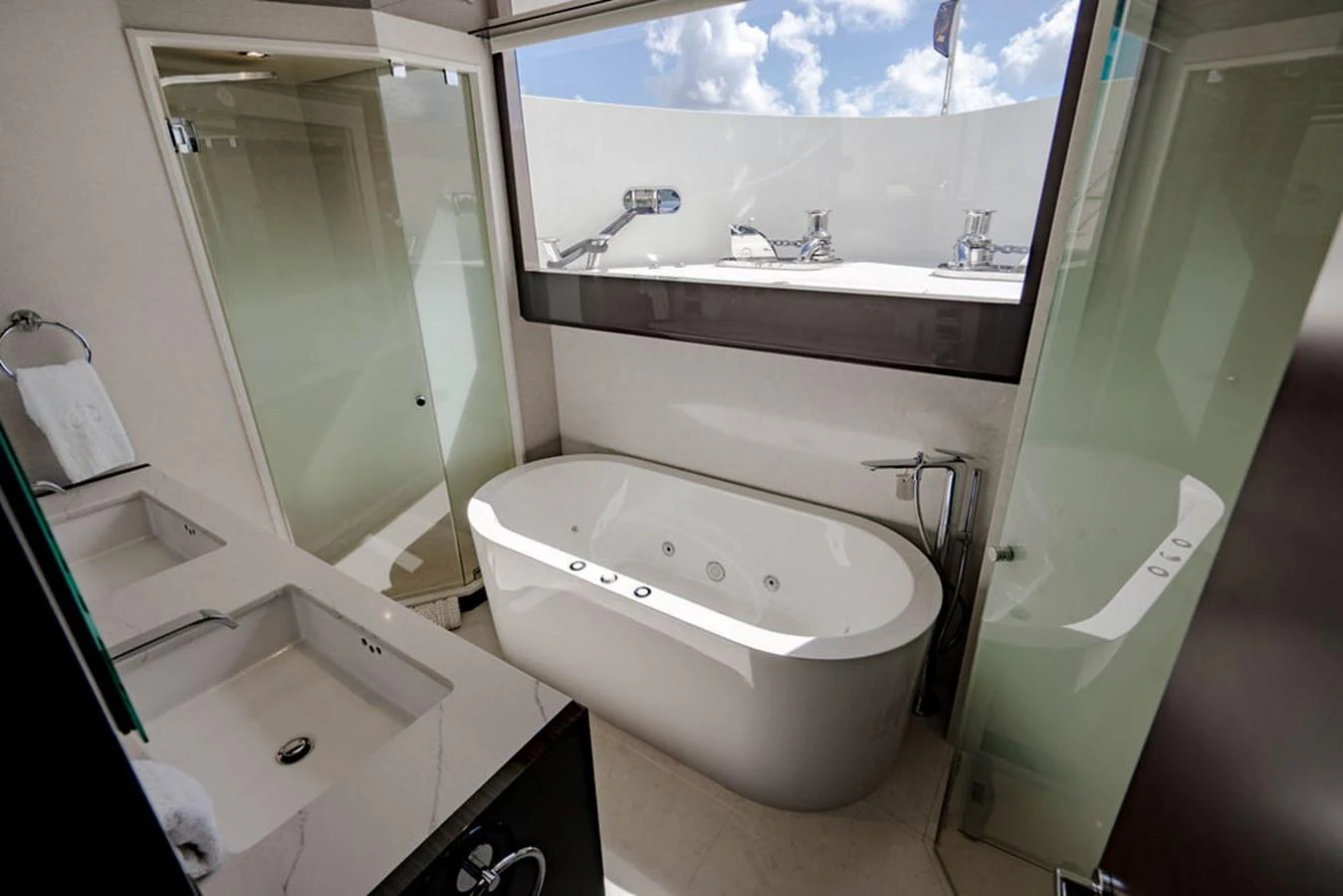 The yacht's bathroom features a luxurious bathtub with modern fixtures and ample natural light. aboard M/Y 12 Yacht for Sale