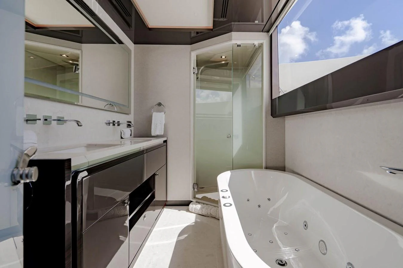 The yacht's bathroom features a modern design with a spacious bathtub and sleek fixtures. aboard M/Y 12 Yacht for Sale