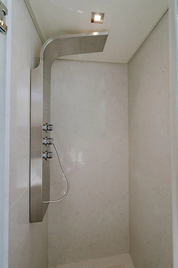A sleek and modern shower with a stainless steel panel and rainfall showerhead. aboard M/Y 12 Yacht for Sale