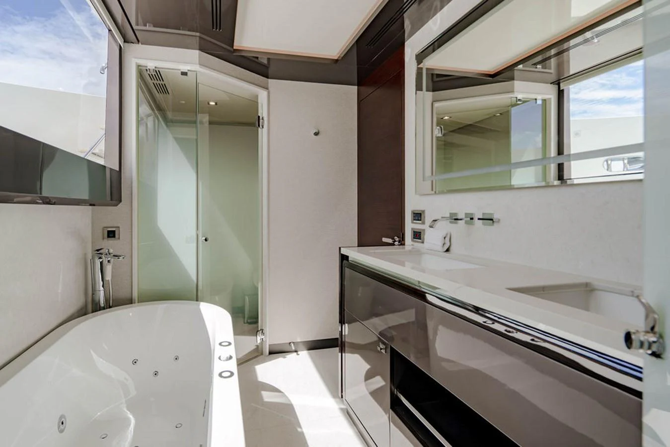 The yacht's bathroom features a sleek design with modern fixtures and a luxurious bathtub. aboard M/Y 12 Yacht for Sale