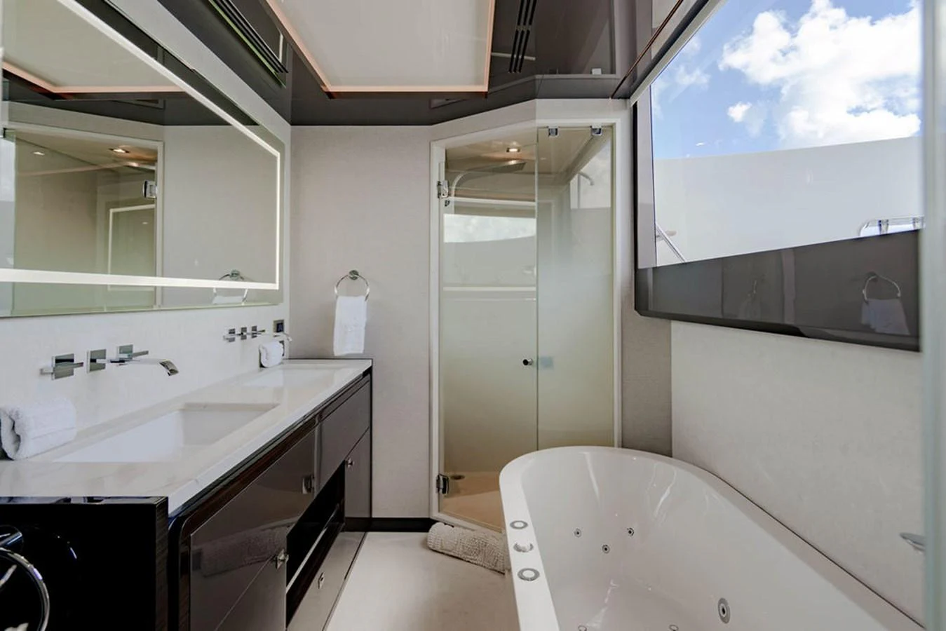 The yacht's bathroom features a luxurious bathtub, sleek countertops, and modern fixtures. aboard M/Y 12 Yacht for Sale