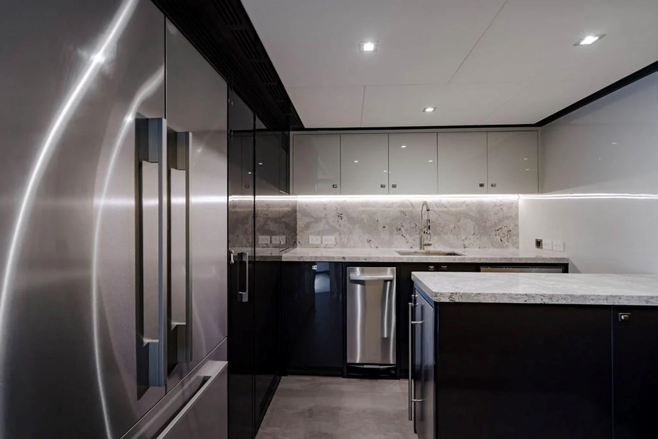 The yacht's galley features modern stainless steel appliances and sleek cabinetry. aboard M/Y 12 Yacht for Sale