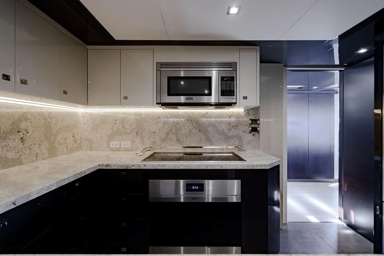 The modern galley features sleek cabinetry, high-end appliances, and elegant stone countertops. aboard M/Y 12 Yacht for Sale