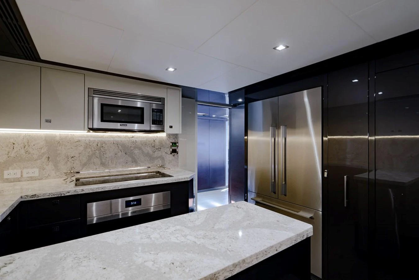 The yacht's galley features modern appliances and sleek countertops, creating a sophisticated culinary space. aboard M/Y 12 Yacht for Sale