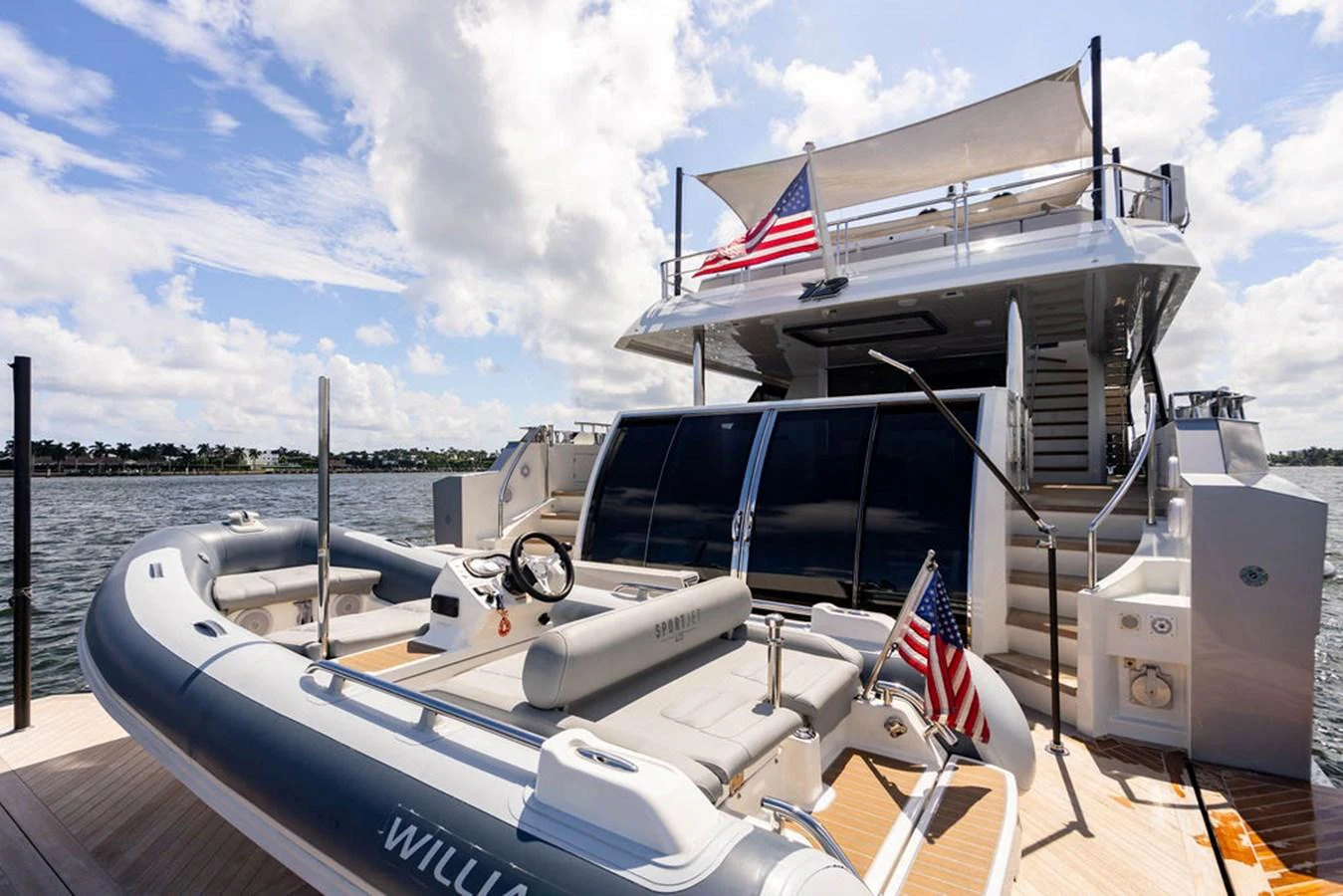 The yacht's aft deck features a tender and a spacious lounging area, perfect for relaxation and water activities. aboard M/Y 12 Yacht for Sale