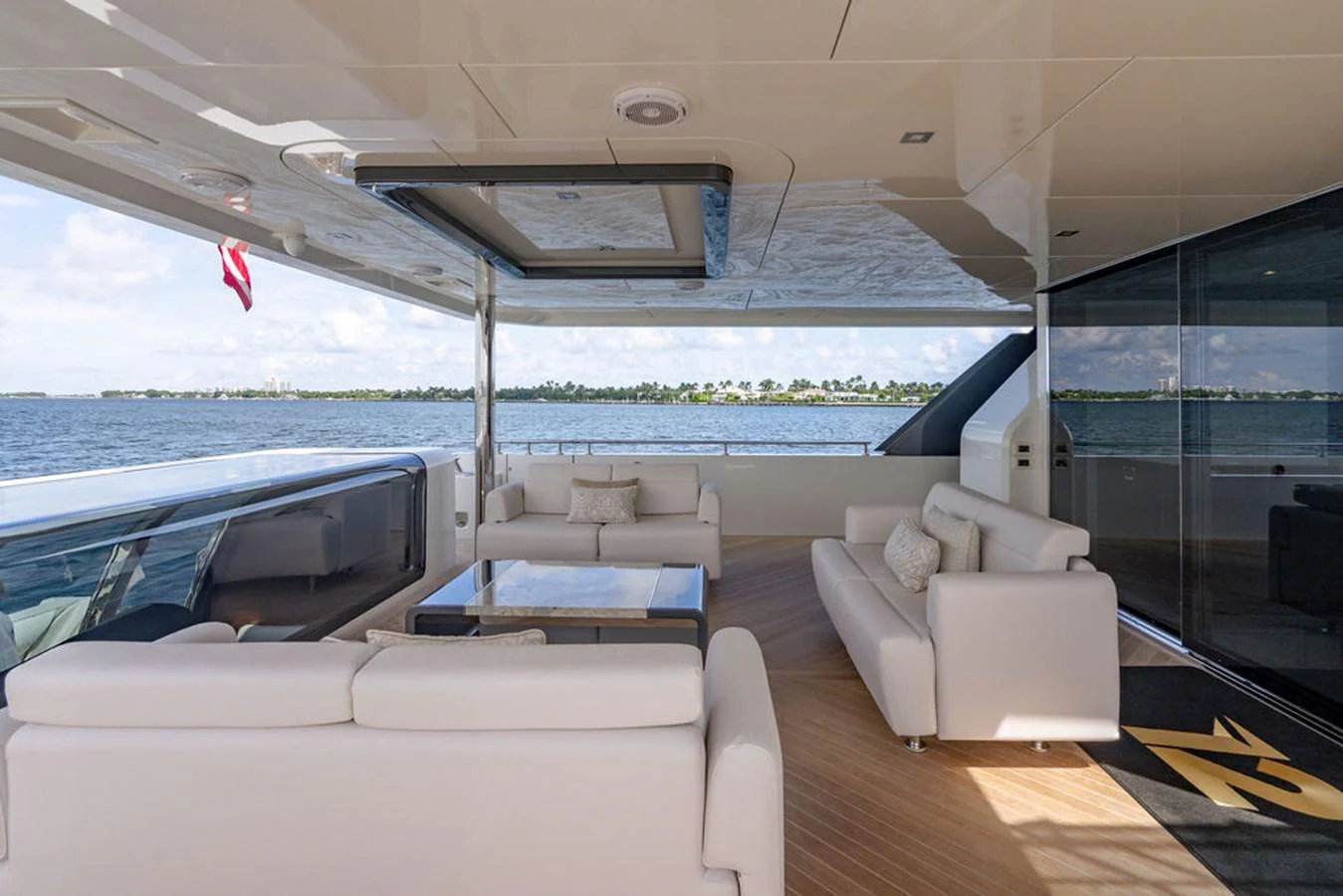 The aft deck offers a luxurious seating area with stunning ocean views. aboard M/Y 12 Yacht for Sale