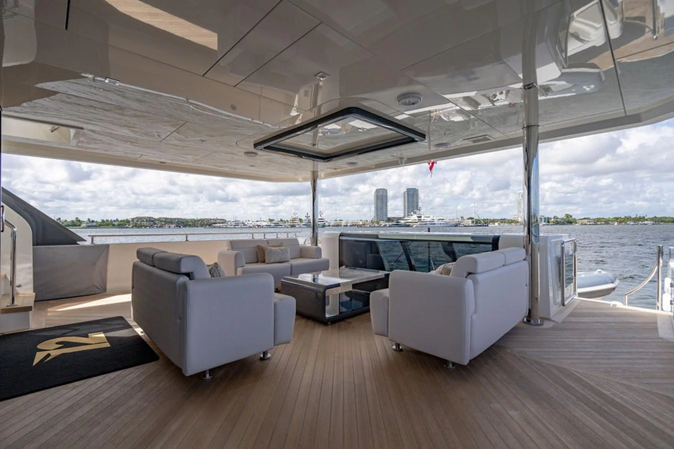 The aft deck features a spacious seating area with modern furnishings and a stunning view of the water. aboard M/Y 12 Yacht for Sale