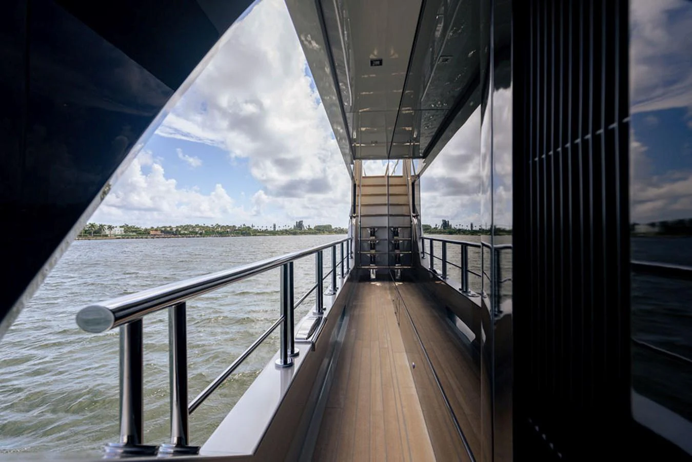 The side deck offers a serene passage with stunning views of the water and sky. aboard M/Y 12 Yacht for Sale