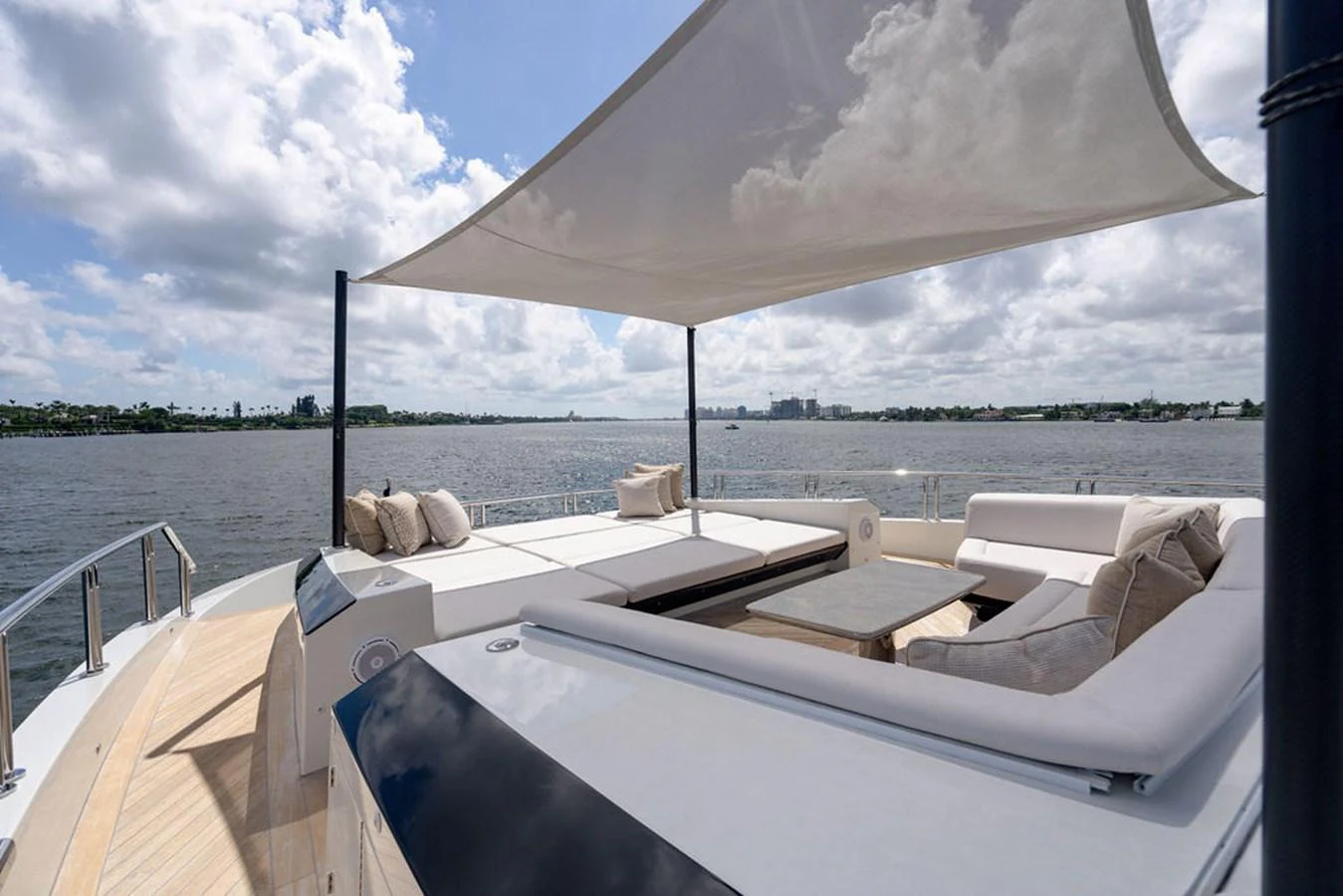 The sundeck offers a luxurious lounging area with ample seating and a shaded canopy, perfect for relaxation and enjoying the view. aboard M/Y 12 Yacht for Sale