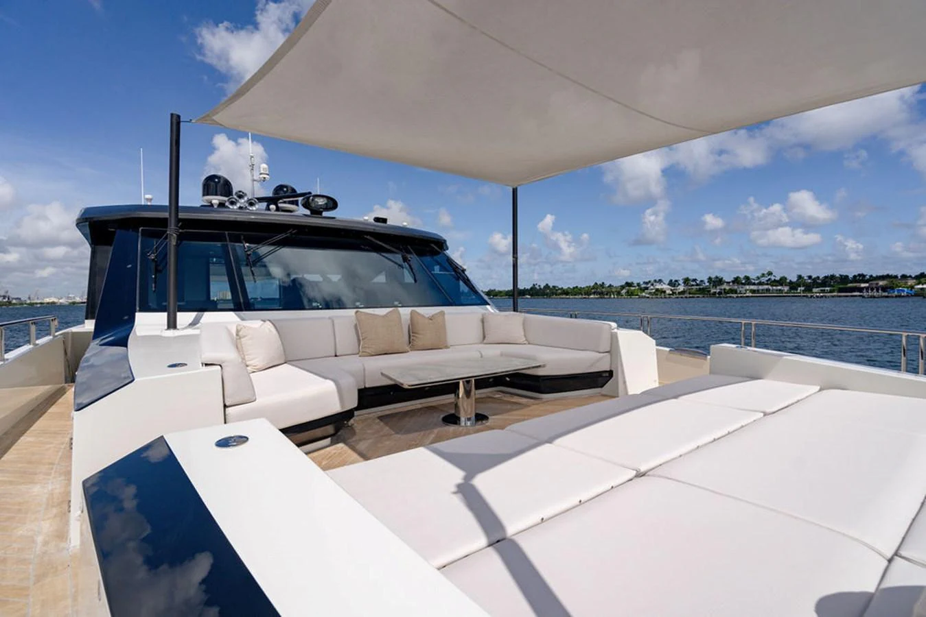 The flybridge offers a spacious seating area with plush cushions and a sunshade, perfect for relaxing and enjoying the view. aboard M/Y 12 Yacht for Sale